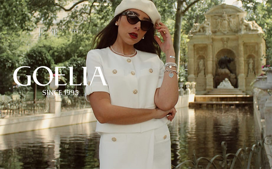 a lady in white acetate suit with sunglasses