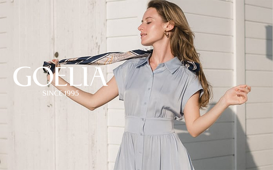 a lady in blue silk shirt dress with silk scarf