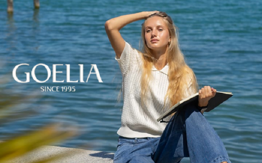 a lady in a white polo knit top and a pair of jeans