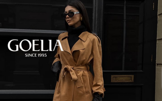 a lady in a black sweater, a pair of black pants and a faux suede trench coat