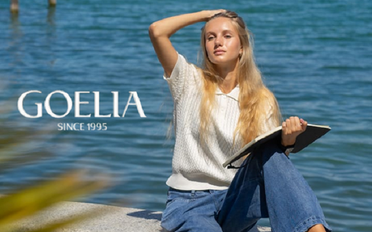 a lady in a white polo shirt and a pair of jeans