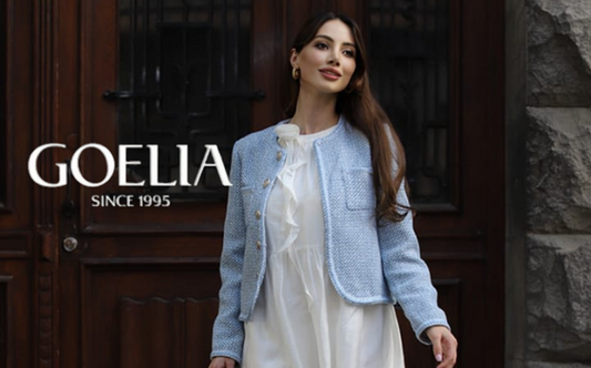 a lady in a blue tweed jacket and a white halter neck dress