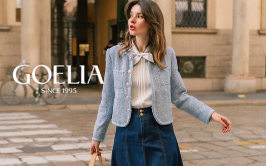 a lady in a white pleated shirt, a blue tweed jacket and an A-line denim skirt