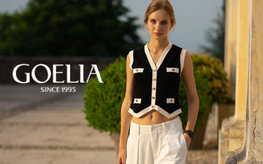 a lady in a black vest and a pair of white jeans