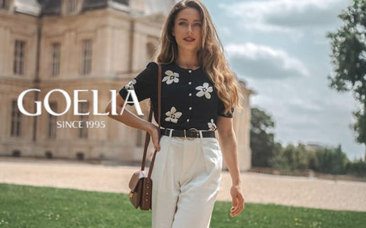 a lady in a black tencel silk blend floral jacquard cardigan and a pair of white jeans