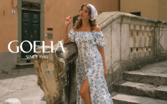 a lady in a blue floral printed off the shoulder slit dress