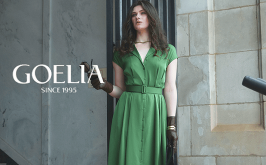 a lady in a green silk dress with a belt