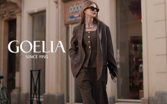 a lady in a brown wool vest, a blazer and a pair of pants