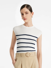 a lady in an acetate knitted striped pullover knit top