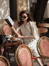 A lady wears a printed skirt.