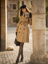 A lady wears a double-breasted trench coat.