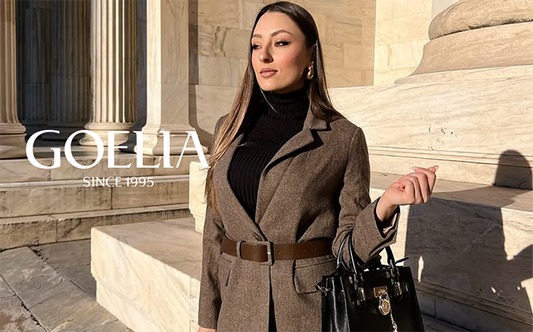 a lady in a dark brown blazer with a black turtleneck top 