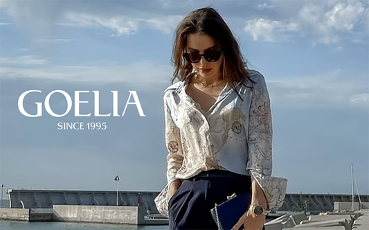 a lady in map printed shirt with navy blue capri pants 