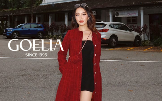 a lady in a black strapless dress and a red tweed long jacket