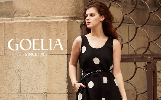 a lady in a black dress with white polka dots