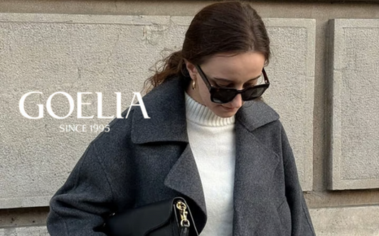 a lady in a white sweater and a grey wool jacket