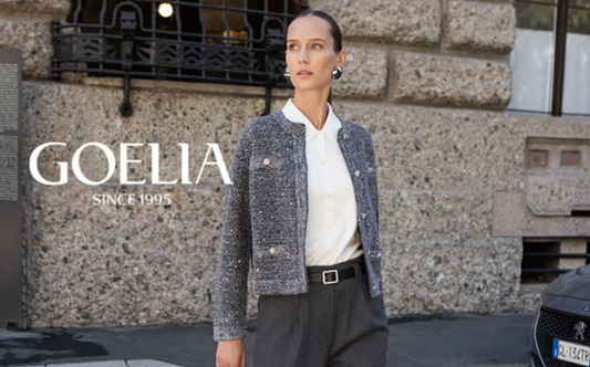 a lady in a white shirt, a grey sequin tweed jacket and a pair of grey pants