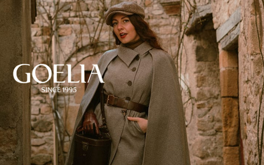 a lady in a brown cape and vest two-piece set and a pair of brown wool shorts