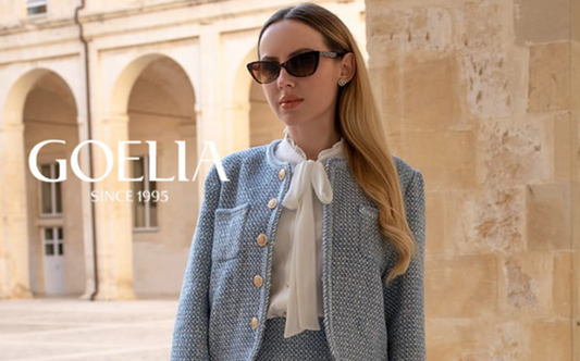 a lady in a white bow tie neck shirt, a blue tweed jacket and a blue tweed skirt