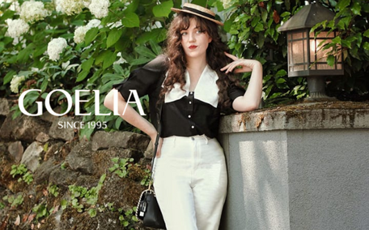 a lady in a black and white patchwork lapel shirt and a pair of white pants