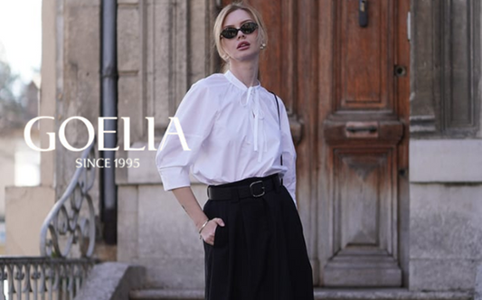 a lady in a white shirt and a black maxi skirt with a belt