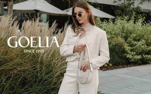 a lady in a white mesh top, a white tweed jacket and a pair of white jeans