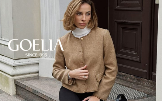 a lady in a white mock neck top, a brown jacket and a pair of skinny pants