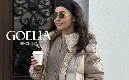 a lady in a grey cardigan and a rose gold down coat