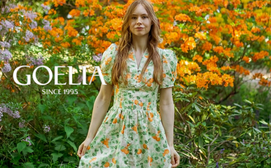 a lady in a green orange printed dress