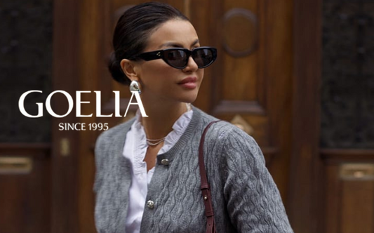 a lady in a white ruffle collared shirt and a grey short cardigan