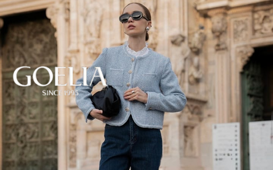 a lady in a blue tweed jacket, a pair of jeans and a pair of black loafers