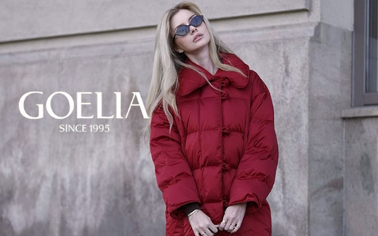 a lady in a red down coat and a black pleated midi skirt
