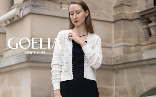 a lady in a black slip dress and a white cardigan