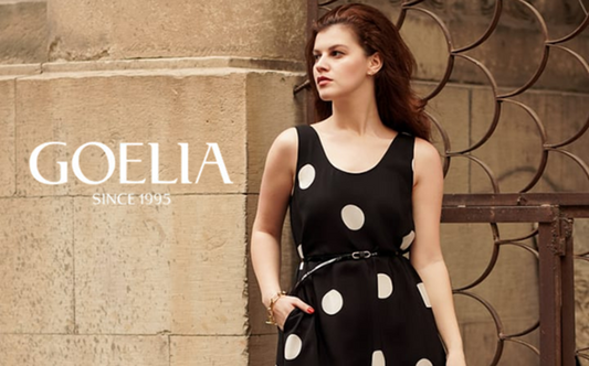 a lady in a black slip dress with white polka dots