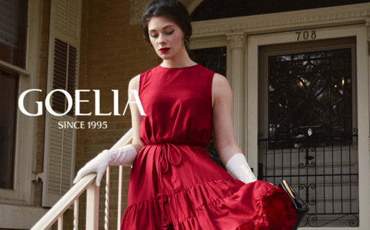 a lady in a red ruffle hem tiered vest dress with a belt