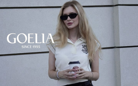 a lady in a beige polo shirt and a black denim slit skirt
