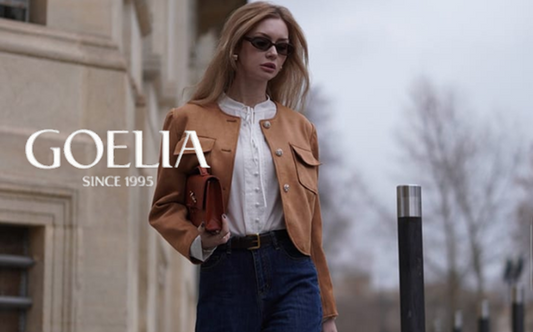 a lady in a white shirt, a faux suede jacket, a pair of jeans and a pair of ankle boots
