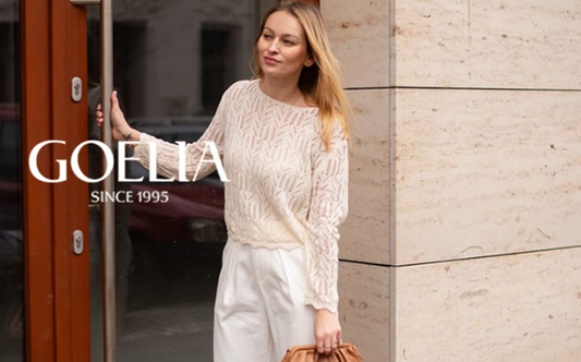 a lady in an openwork linen sweater and a pair of white wide leg pants