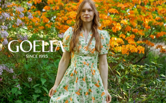 a lady in a green orange printed dress