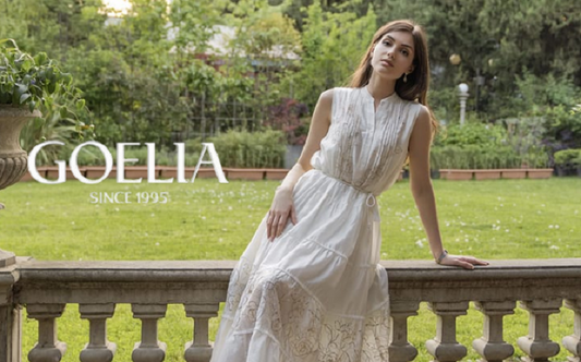 a lady in a white embroidered white vest dress