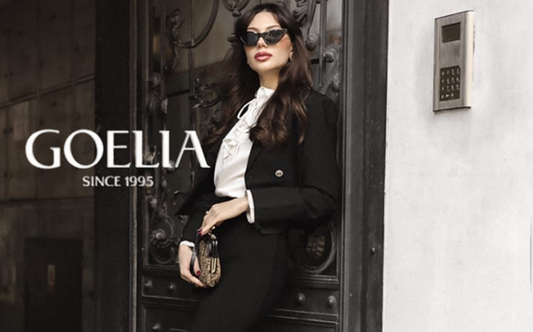 a lady in a white blouse, a black blazer and a black slit skirt