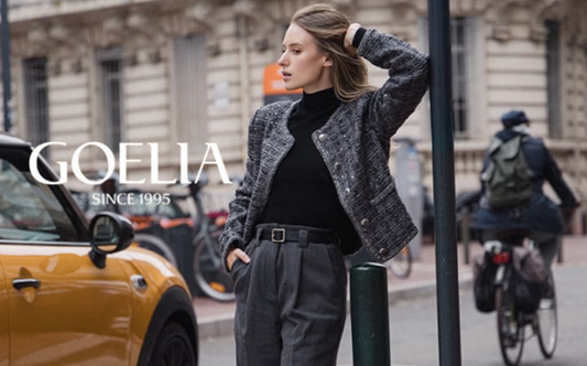 a lady in a black knit top, a grey wool blend tweed sequins jacket and a pair of grey pants