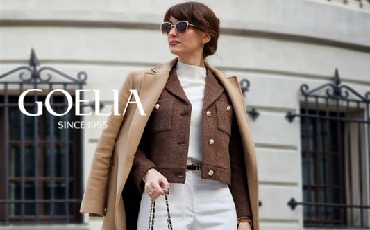 a lady in a white slim sweater, a brown jacket, a pair of white pants and a long coat