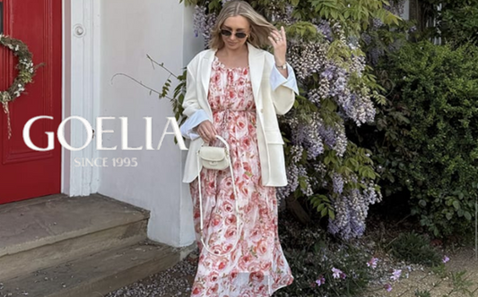a lady in a pink rose printed dress and a white blazer