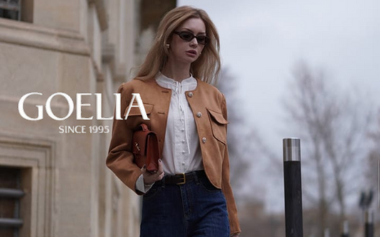 a lady in a white blouse, a faux suede jacket and a pair of jeans