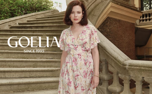a lady in a pink floral printed silk dress