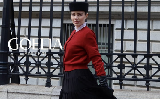 a lady in a red sweater and a black tiered skirt