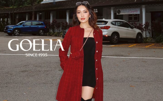 a lady in a black mini dress and a red tweed single-breasted coat