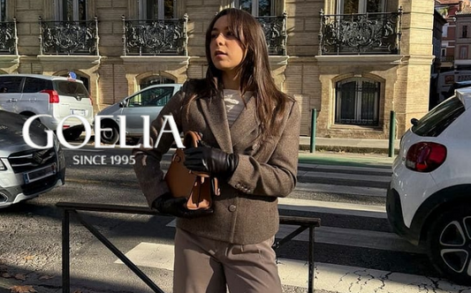 a lady in a white top, a brown lapel wool blazer and a pair of dark brown wool pants