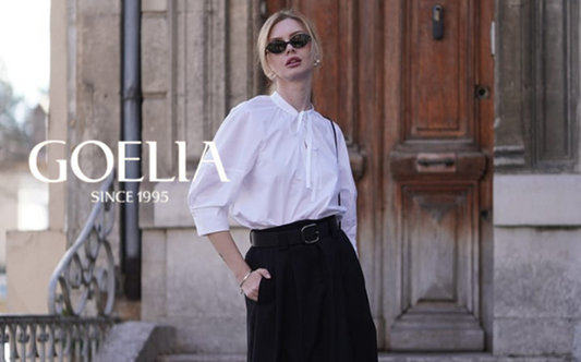 a lady in a white lapel cotton shirt and a black skirt with a belt